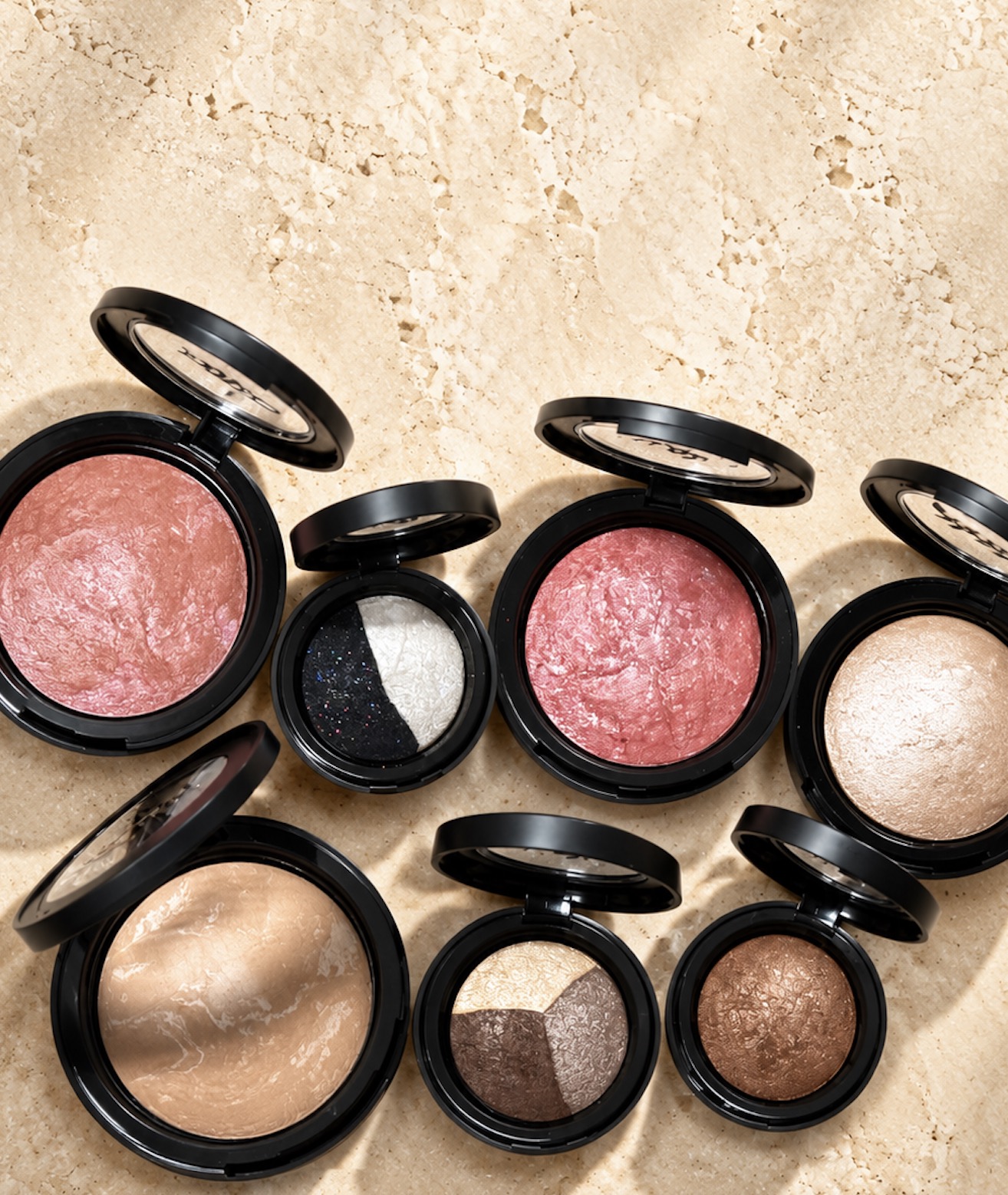 Open ingredientlogic mineral makeup compacts arranged on sunlit stone